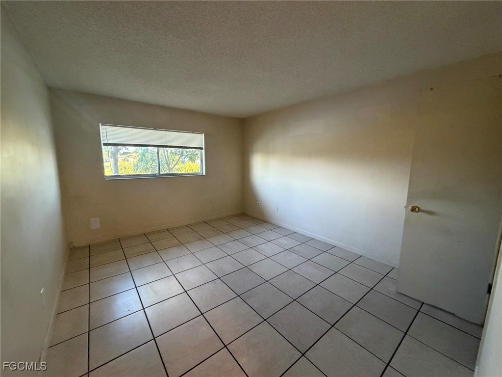 817 Gleason Parkway, Unit 3 Cape Coral, FL 33914 - Photo 6 of 12 a view of an empty room and window