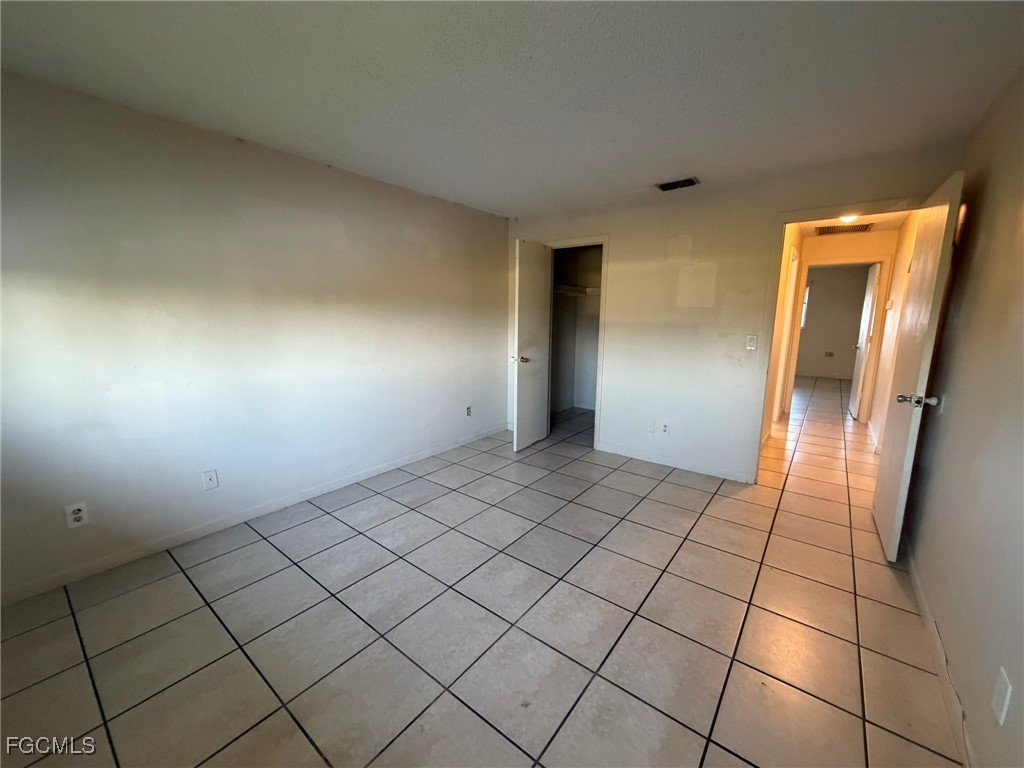 817 Gleason Parkway, Unit 3 Cape Coral, FL 33914 - Photo 7 of 12 a view of an empty room and wooden floor