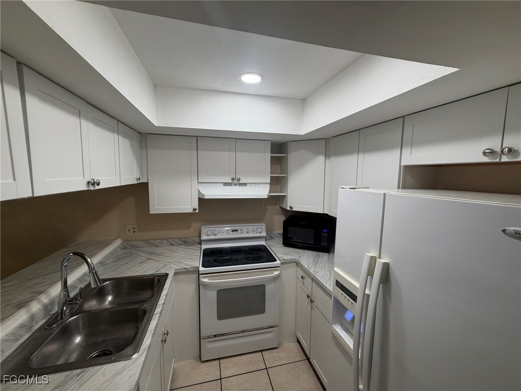 817 Gleason Parkway, Unit 3 Cape Coral, FL 33914 - Photo 8 of 12 a kitchen with a sink stove and refrigerator