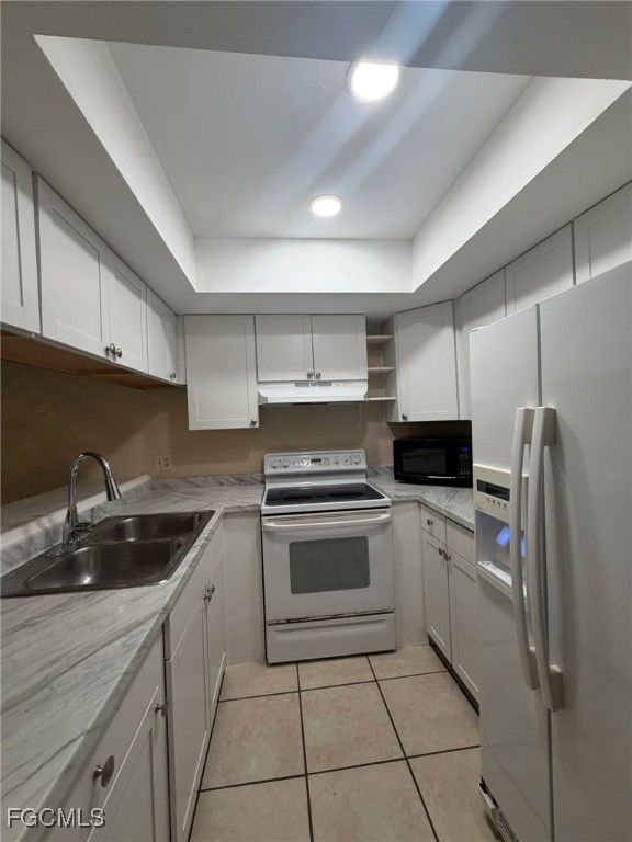 817 Gleason Parkway, Unit 3 Cape Coral, FL 33914 - Photo 9 of 12 a kitchen with a sink cabinets and stainless steel appliances