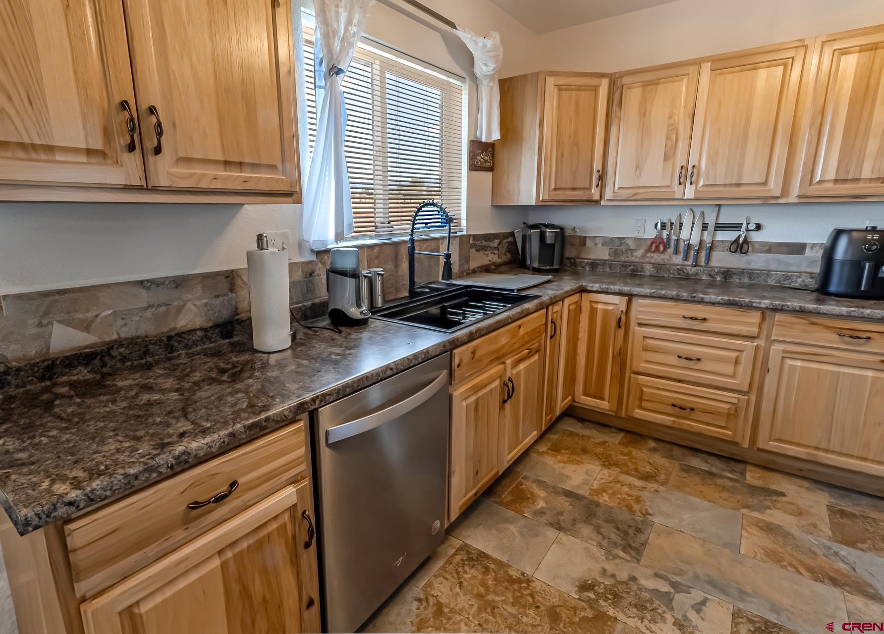 15969 Stardust Lane Cedaredge, CO 81413 - Photo 15 of 44 a kitchen with stainless steel appliances granite countertop a sink a stove and cabinets