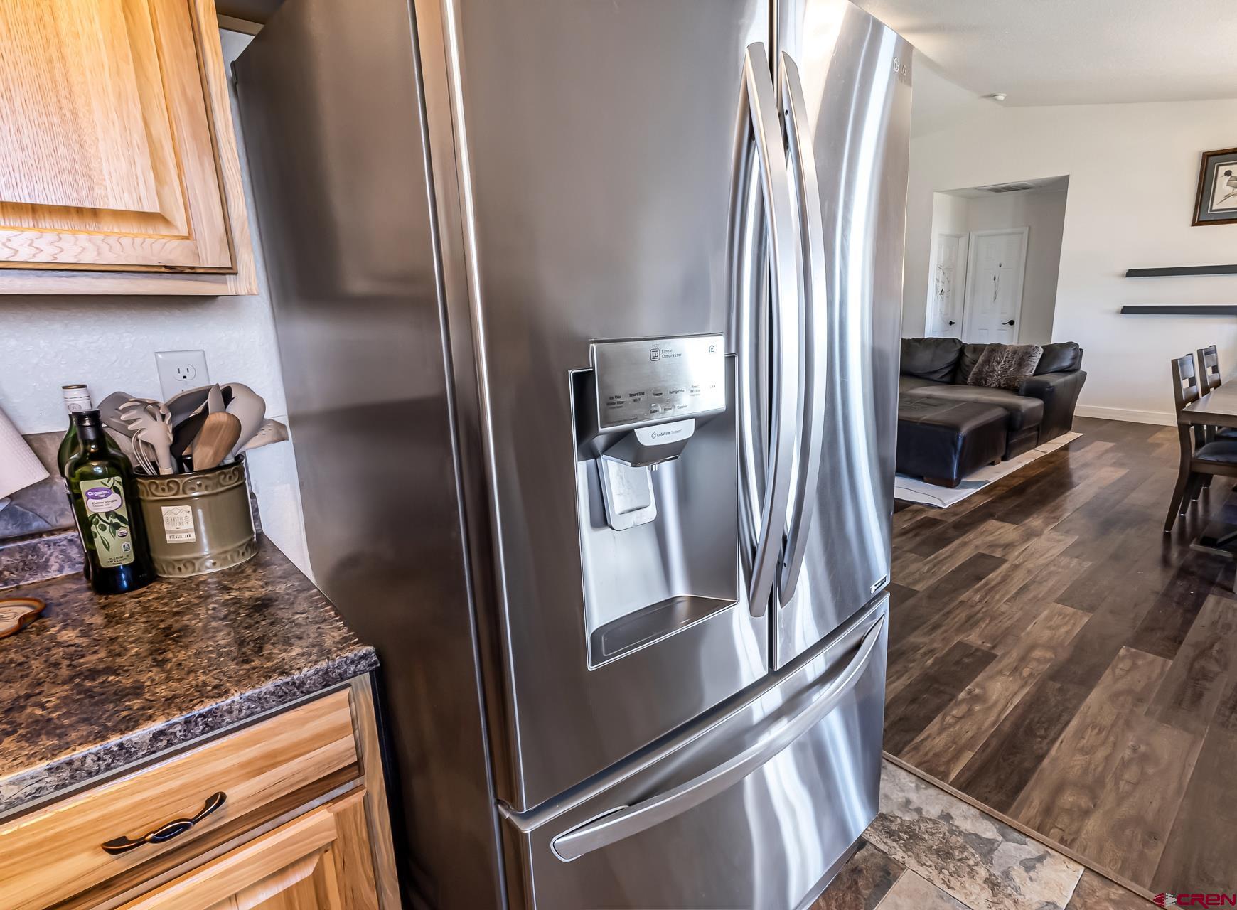 15969 Stardust Lane Cedaredge, CO 81413 - Photo 17 of 44 a kitchen with granite countertop a refrigerator stove and sink