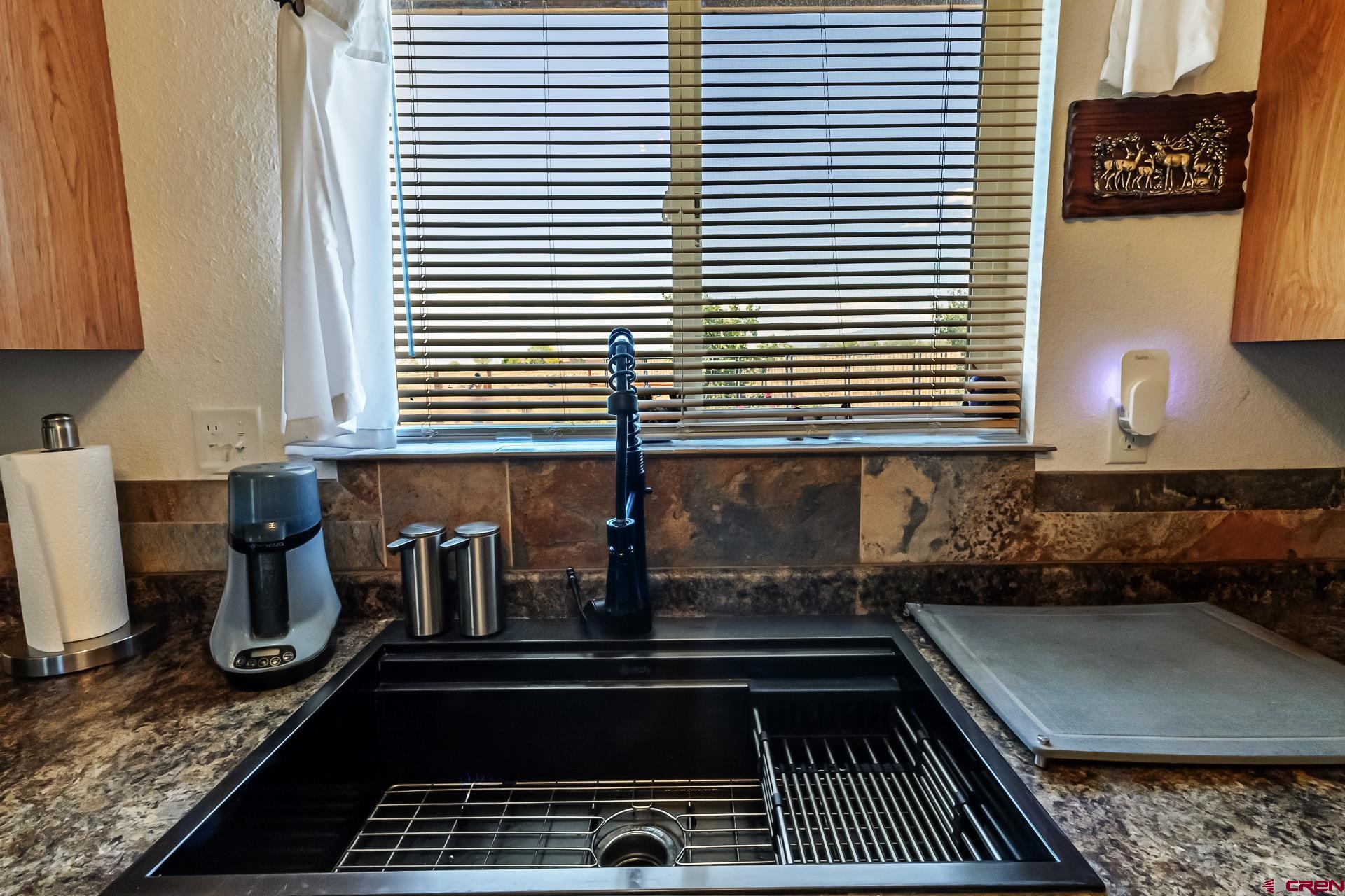 15969 Stardust Lane Cedaredge, CO 81413 - Photo 18 of 44 a kitchen with a sink and a stove