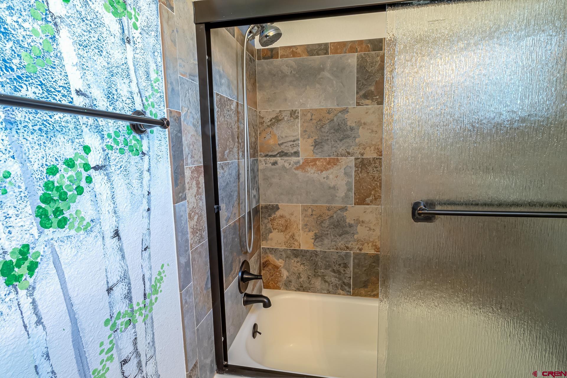 15969 Stardust Lane Cedaredge, CO 81413 - Photo 21 of 44 a bathroom with a glass shower door