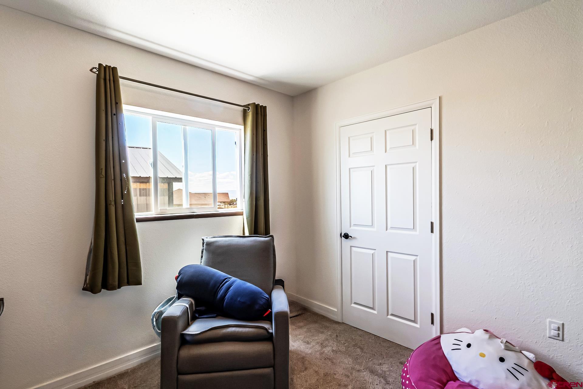 15969 Stardust Lane Cedaredge, CO 81413 - Photo 24 of 44 a bedroom with furniture and a window