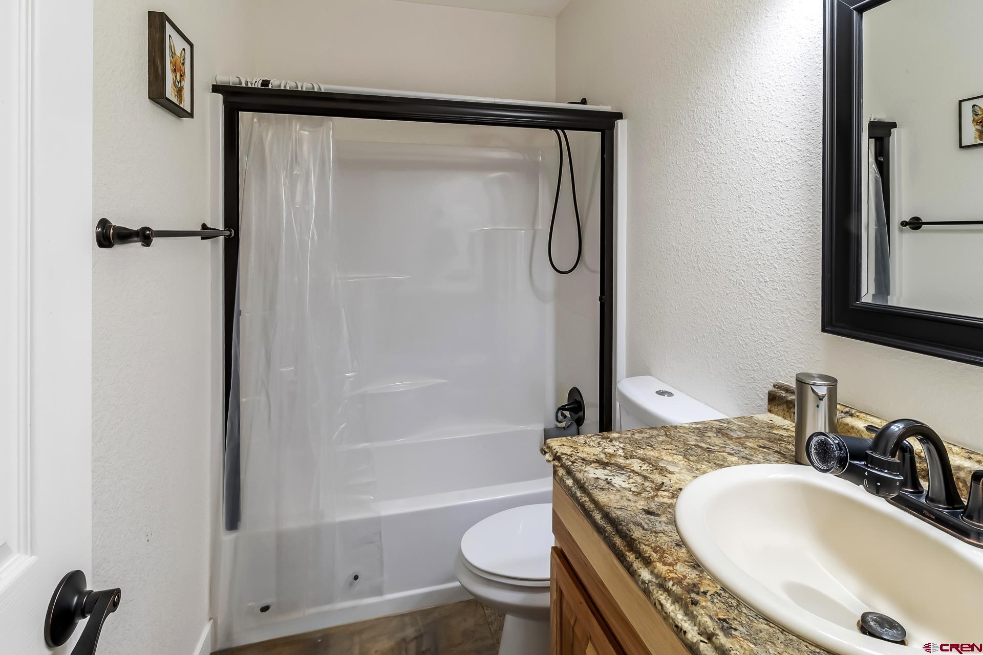 15969 Stardust Lane Cedaredge, CO 81413 - Photo 25 of 44 a bathroom with a sink toilet and shower