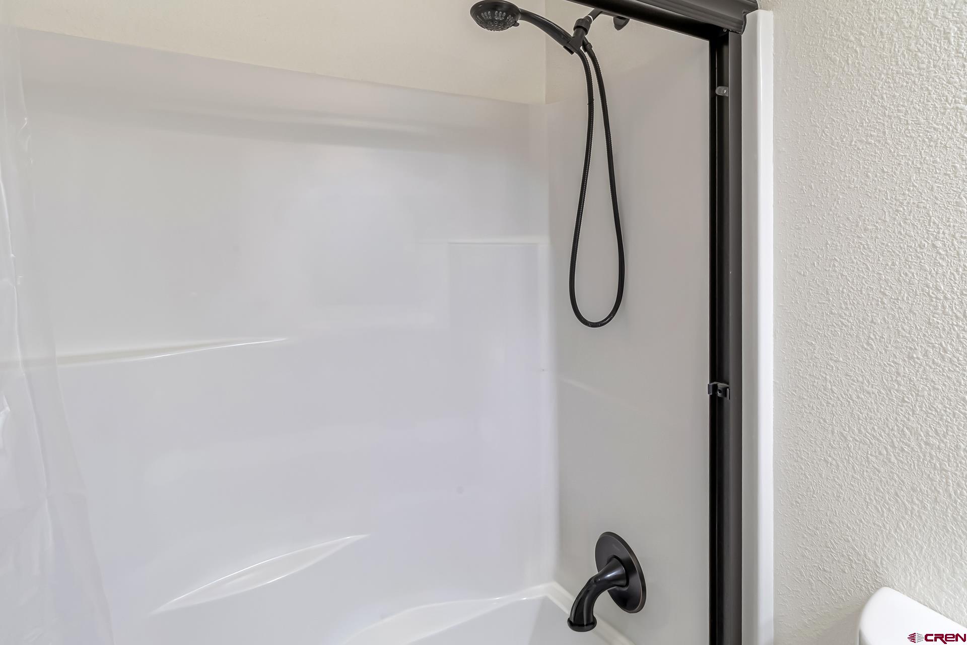 15969 Stardust Lane Cedaredge, CO 81413 - Photo 26 of 44 a bathroom with a glass shower door