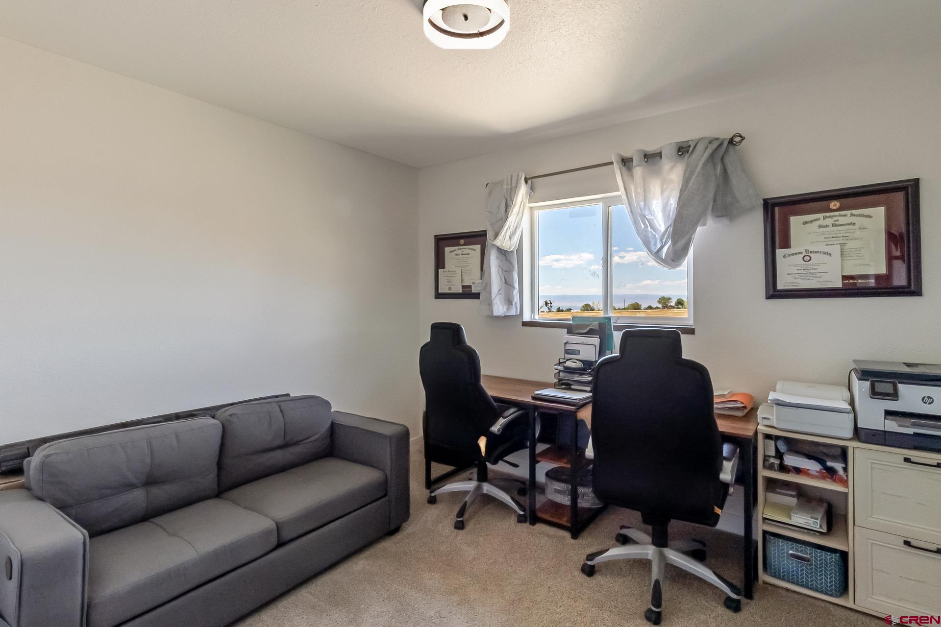 15969 Stardust Lane Cedaredge, CO 81413 - Photo 27 of 44 a livingroom with workspace and a couch