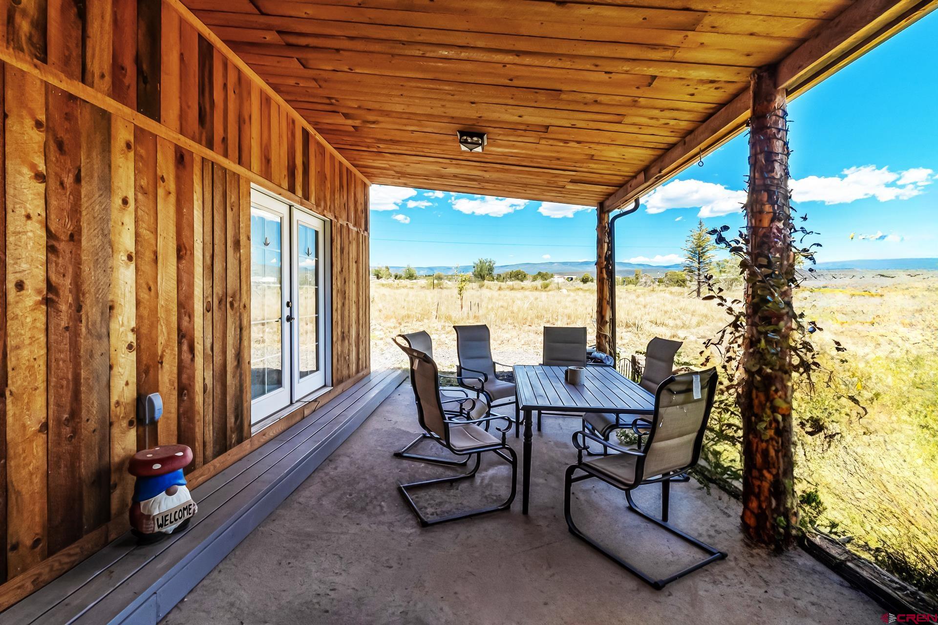 15969 Stardust Lane Cedaredge, CO 81413 - Photo 33 of 44 a view of a patio with a table chairs and a patio