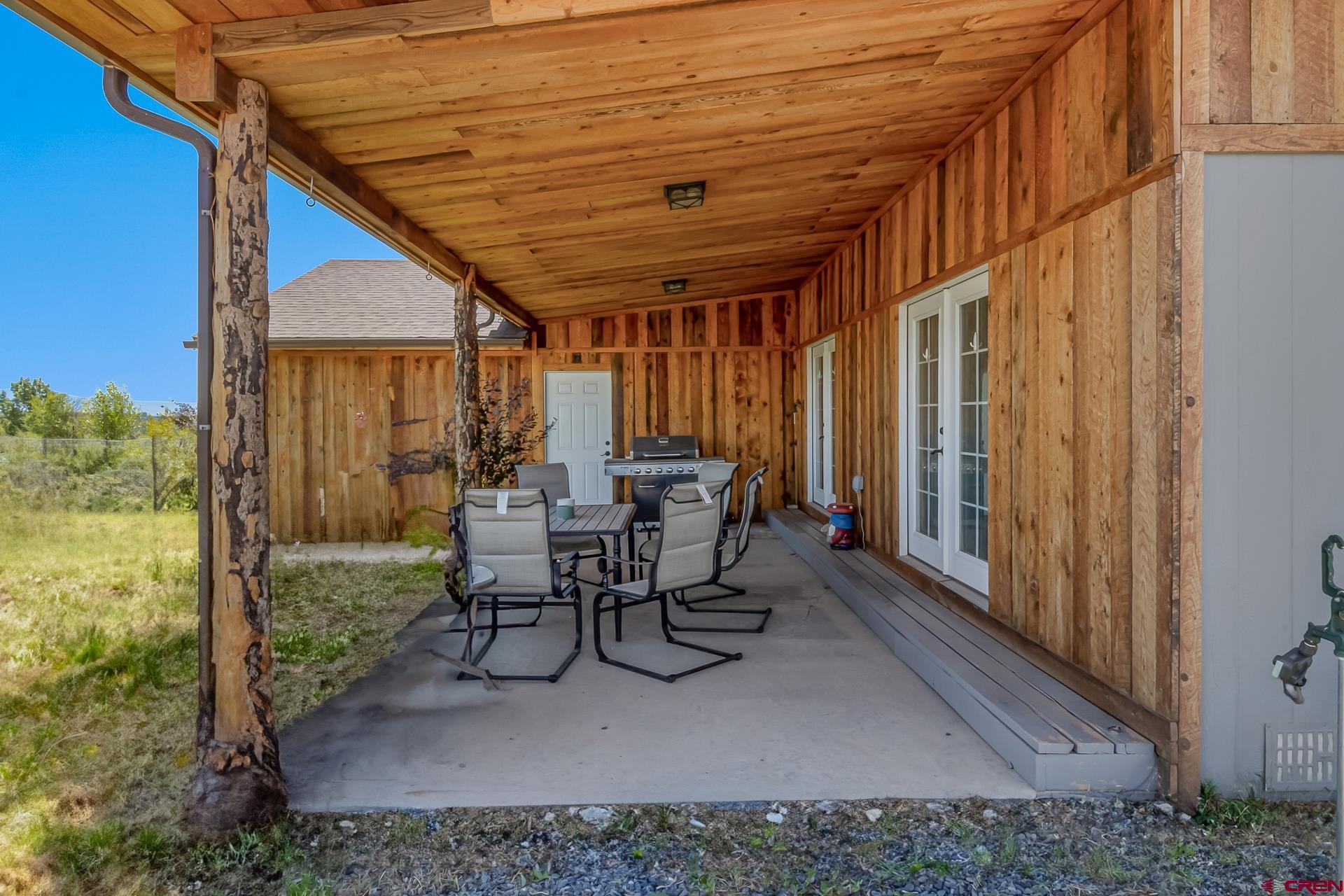15969 Stardust Lane Cedaredge, CO 81413 - Photo 34 of 44 a view of a patio with table and chairs and potted plants