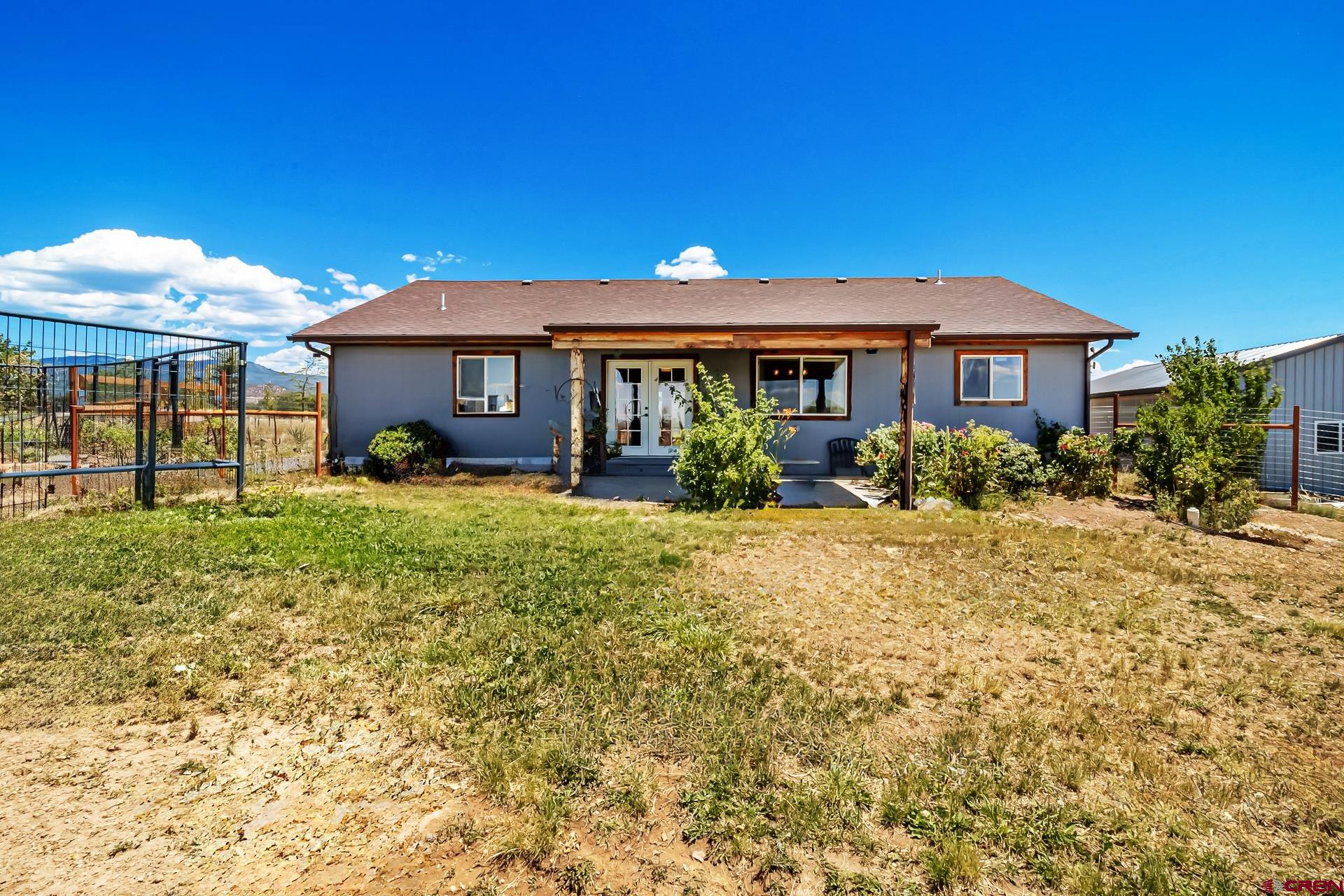 15969 Stardust Lane Cedaredge, CO 81413 - Photo 35 of 44 a front view of a house with garden