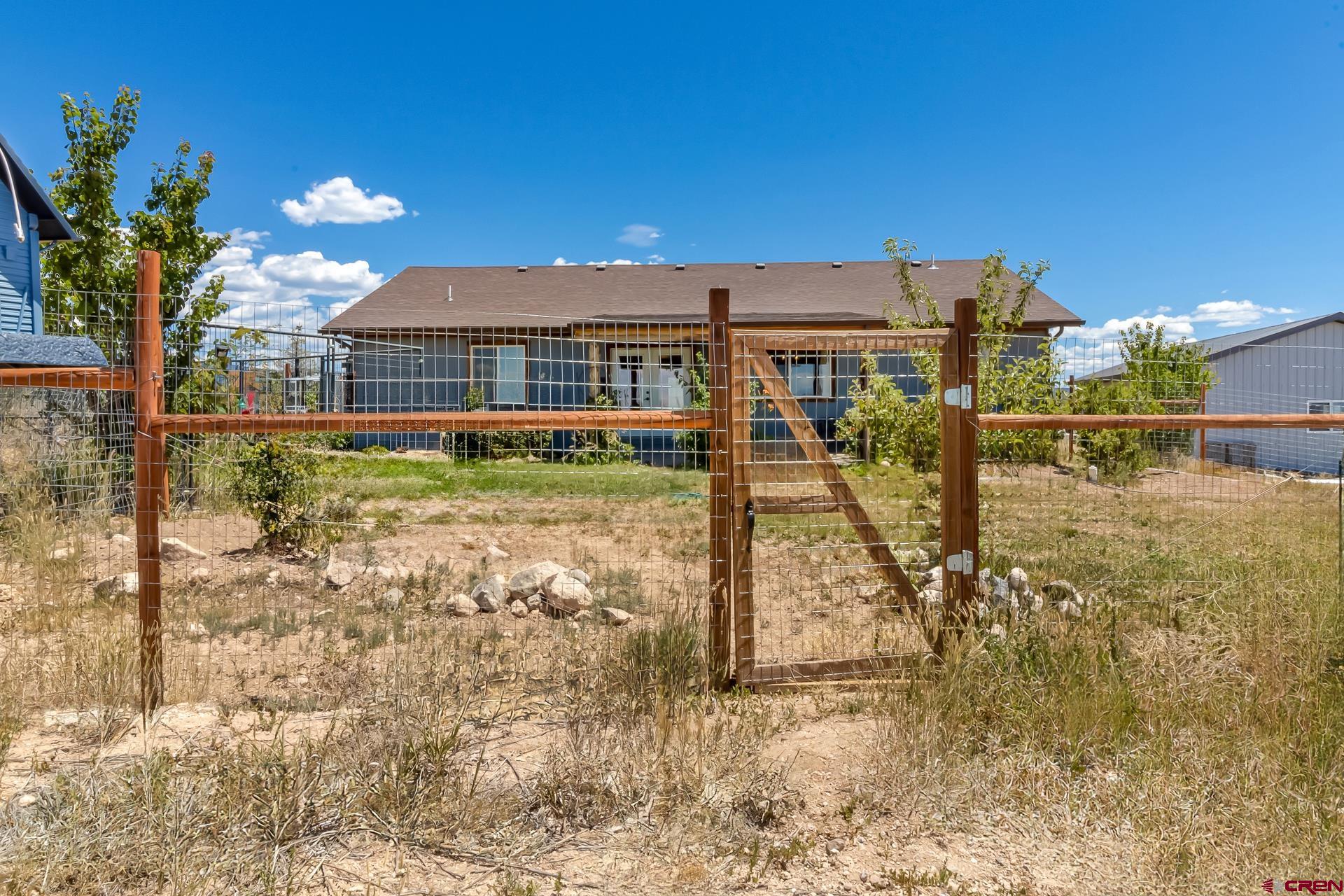 15969 Stardust Lane Cedaredge, CO 81413 - Photo 36 of 44 a view of a house with backyard
