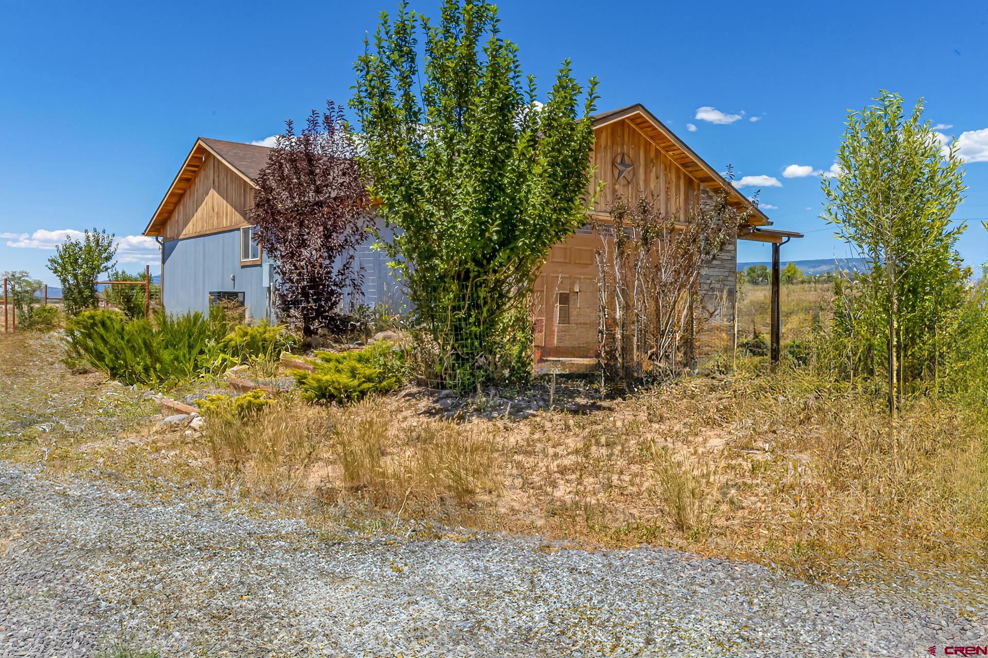 15969 Stardust Lane Cedaredge, CO 81413 - Photo 37 of 44 a view of a house with a yard