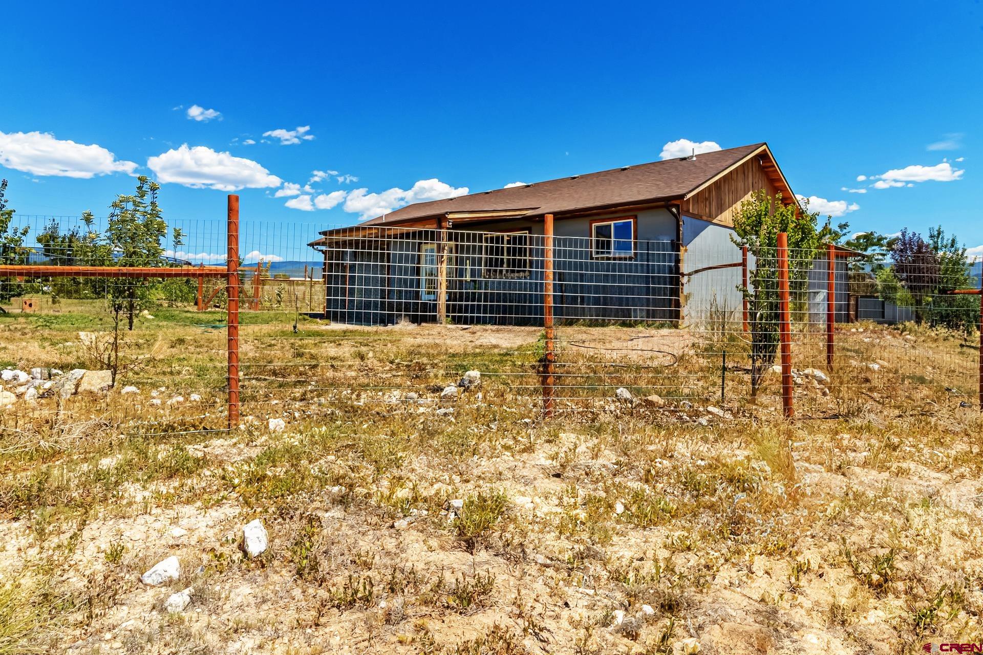 15969 Stardust Lane Cedaredge, CO 81413 - Photo 40 of 44 a view of a house with a yard