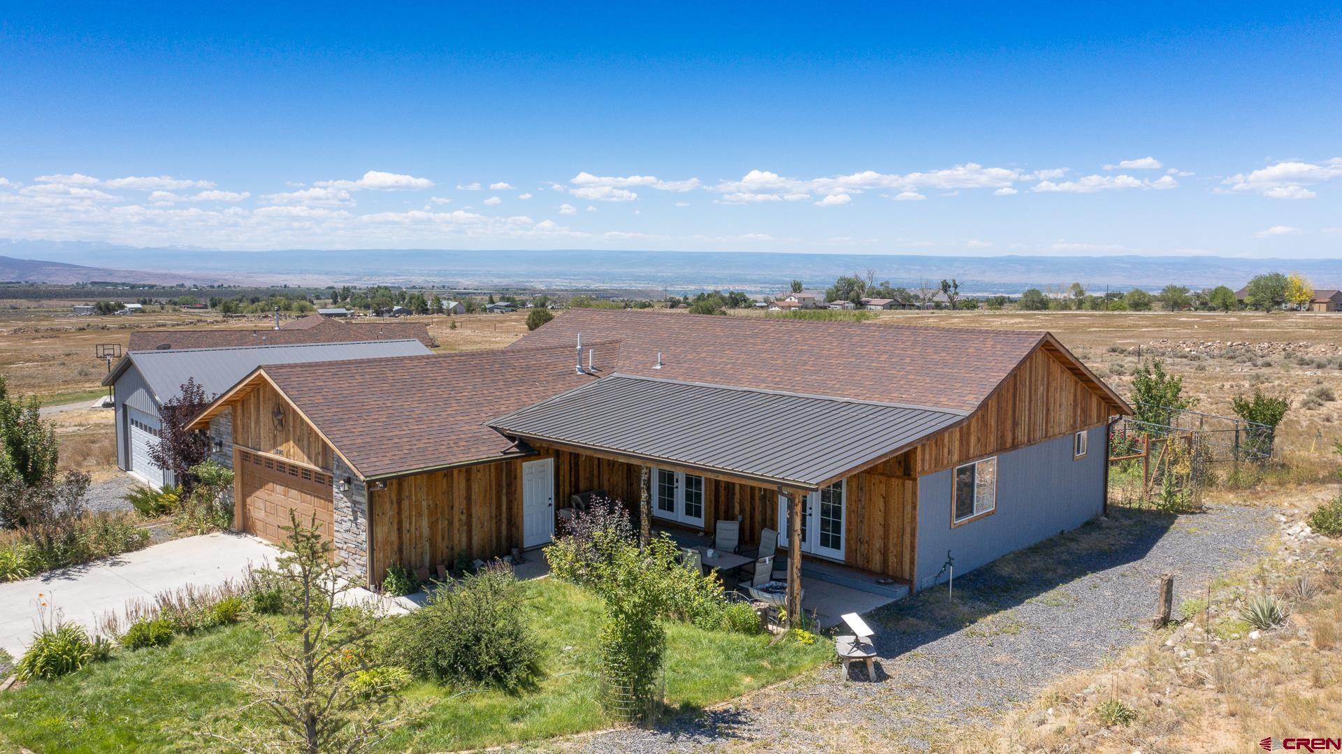 15969 Stardust Lane Cedaredge, CO 81413 - Photo 4 of 44 an aerial view of a house with a yard