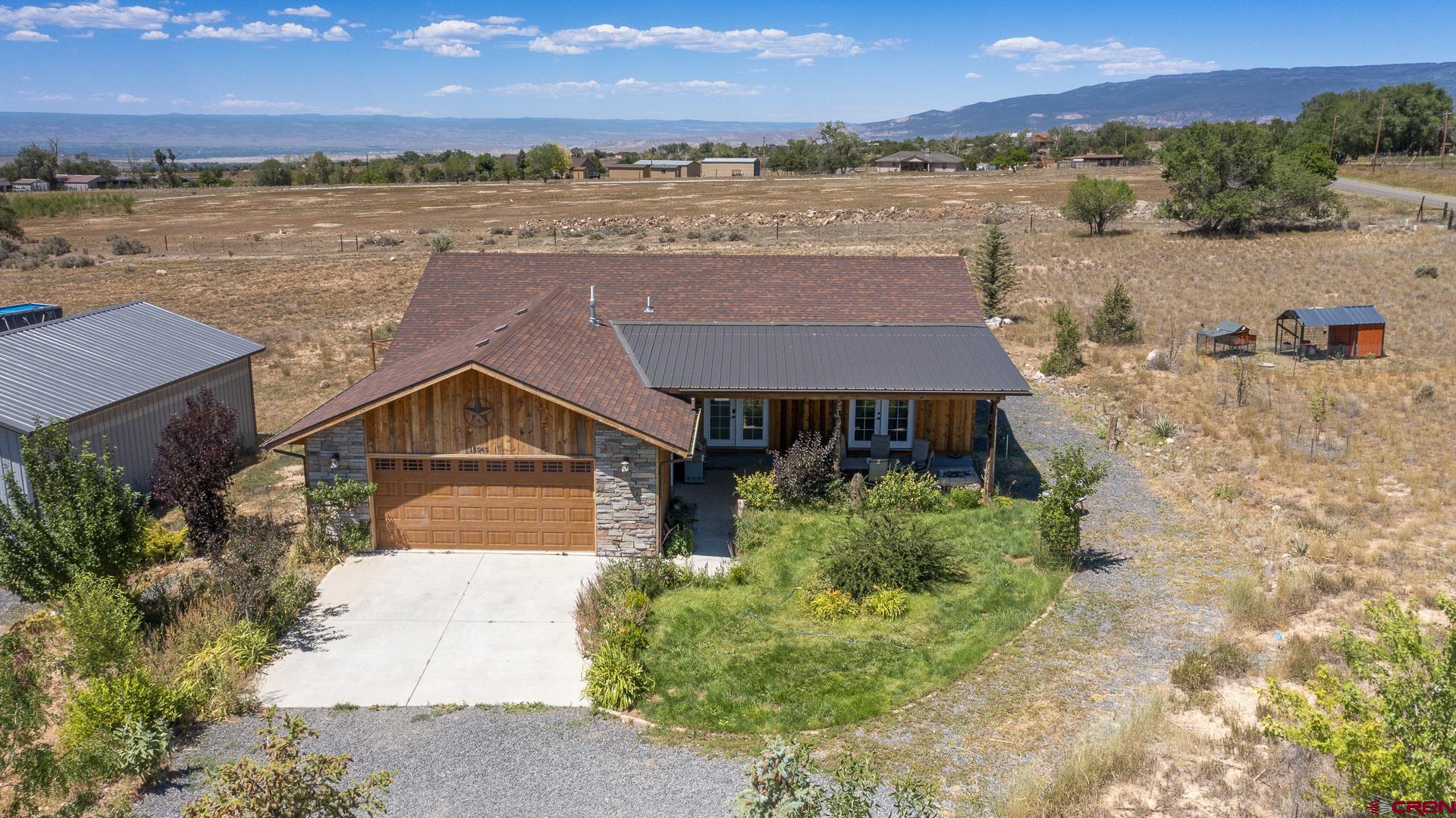 15969 Stardust Lane Cedaredge, CO 81413 - Photo 5 of 44 an aerial view of a house with a yard