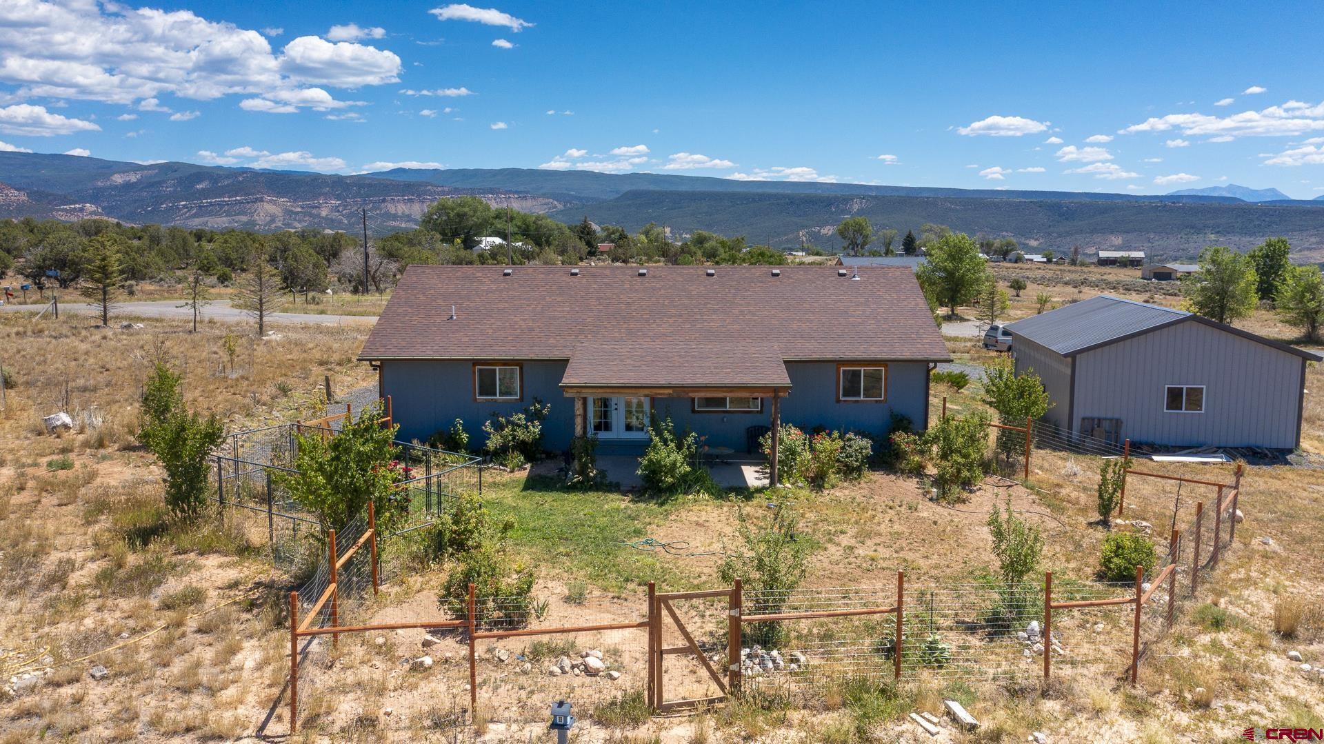 15969 Stardust Lane Cedaredge, CO 81413 - Photo 6 of 44 a view of a house with a yard