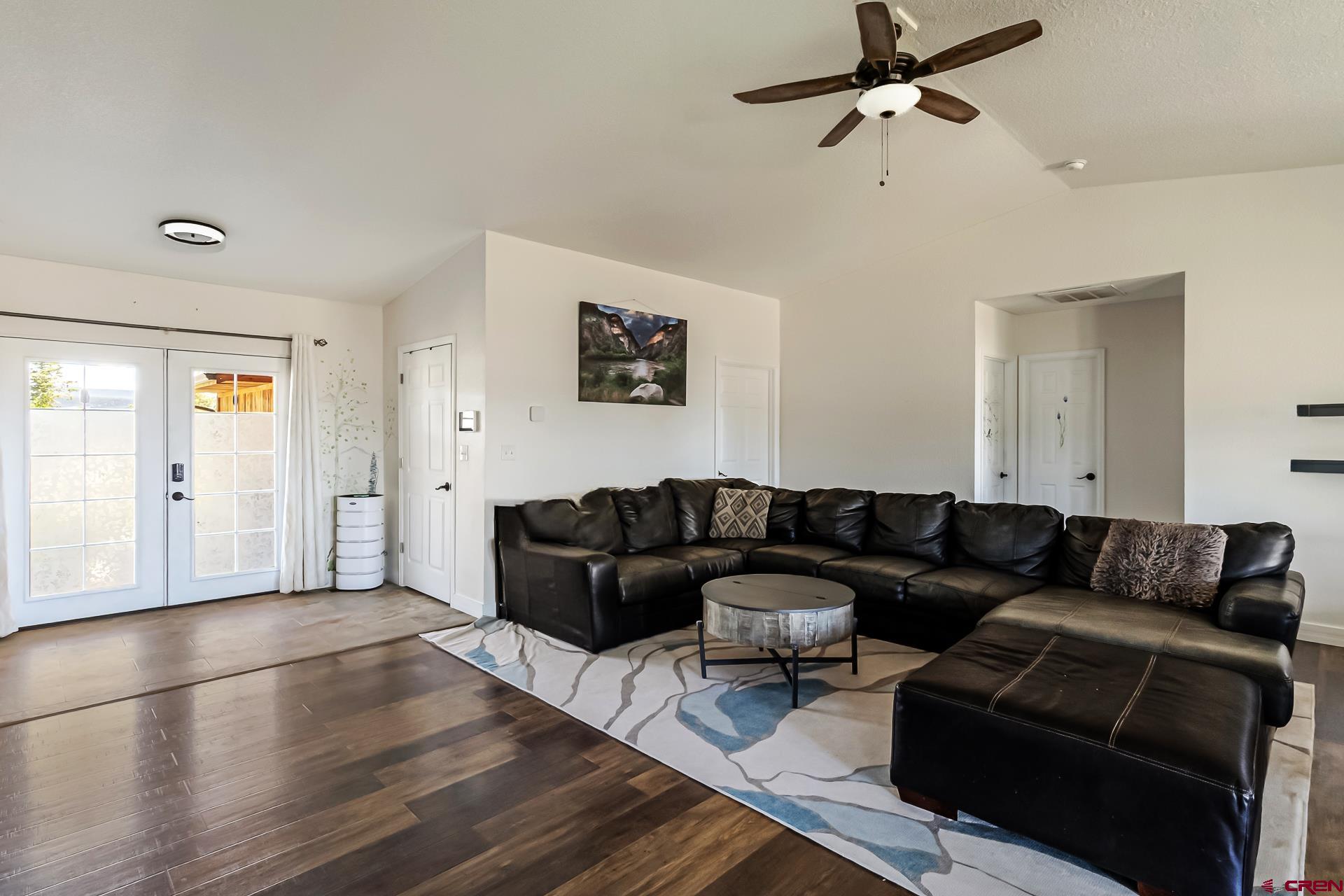 15969 Stardust Lane Cedaredge, CO 81413 - Photo 9 of 44 a living room with furniture and a wooden floor