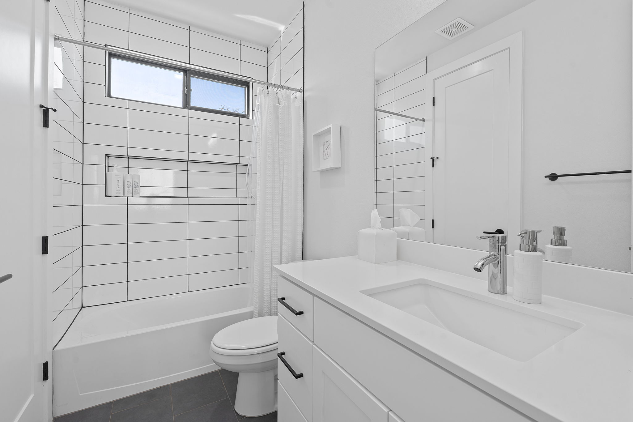 1168 Ridgeway Drive, Unit 2 Austin, TX 78702 - Photo 16 of 26 a bathroom with a sink a toilet and shower