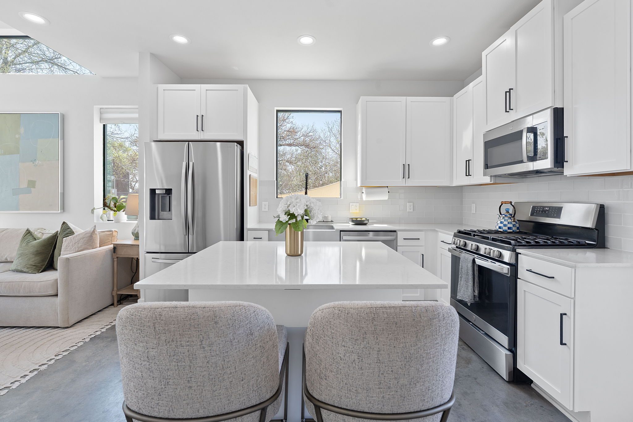 1168 Ridgeway Drive, Unit 2 Austin, TX 78702 - Photo 6 of 26 a kitchen with stainless steel appliances granite countertop a refrigerator a stove a sink a dining table and chairs with wooden floor