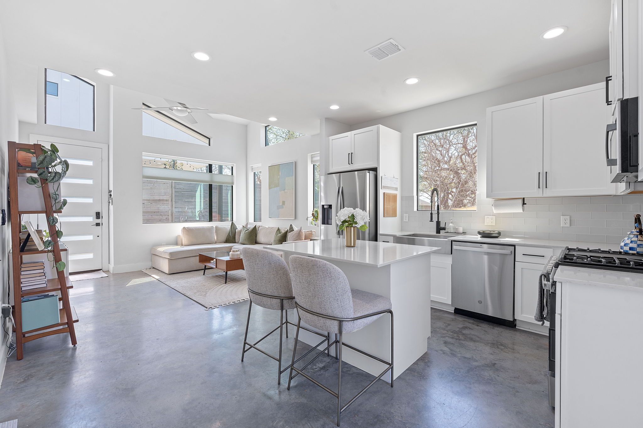 1168 Ridgeway Drive, Unit 2 Austin, TX 78702 - Photo 7 of 26 a kitchen with stainless steel appliances kitchen island granite countertop a table chairs sink and cabinets