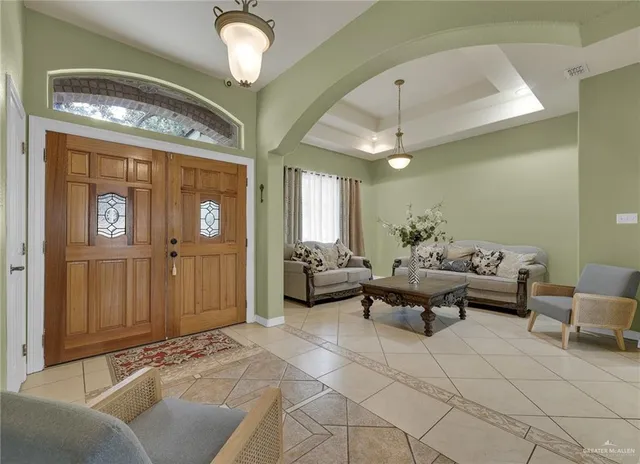 a living room with furniture and a chandelier