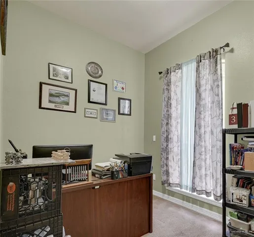 a living room with furniture a bookshelf and a window