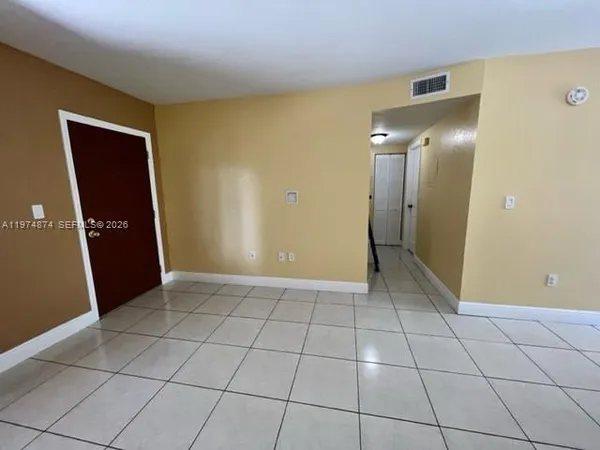 a view of a livingroom with an empty space and a window