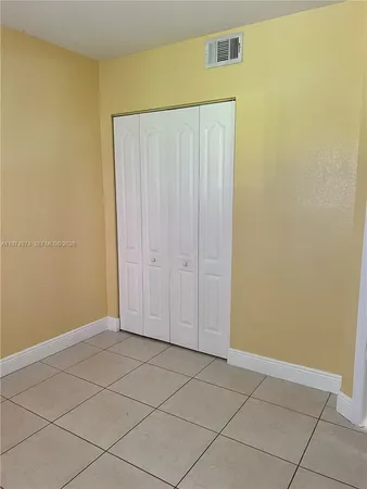 a view of a room with an empty space and a window