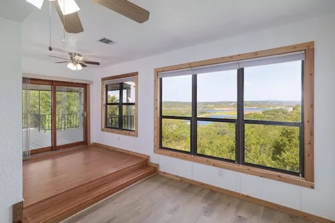 a bathroom with a granite countertop sink mirror bathtub and toilet