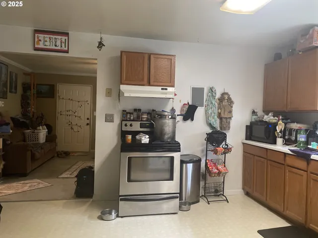 a kitchen with stainless steel appliances granite countertop a stove and cabinets