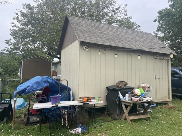 a backyard of a house with table and chairs