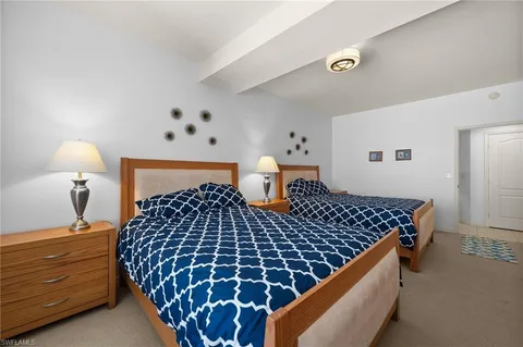 a bedroom with a bed and a night stand