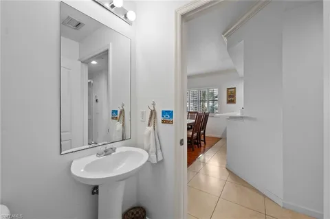 a bathroom with a sink a toilet a mirror and shower
