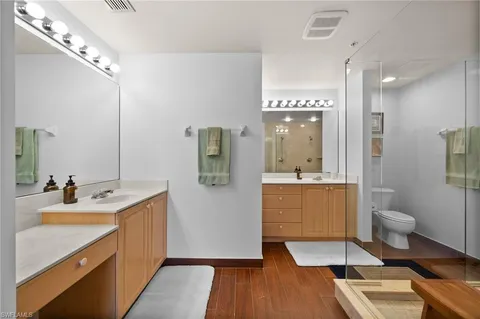 a bathroom with a sink mirror and shower