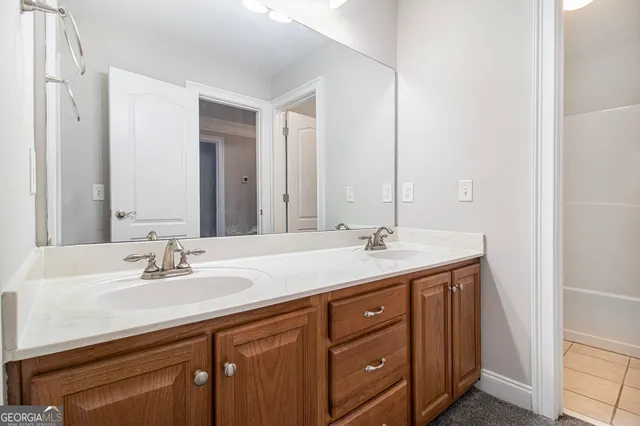 a bathroom with a sink double vanity and a mirror
