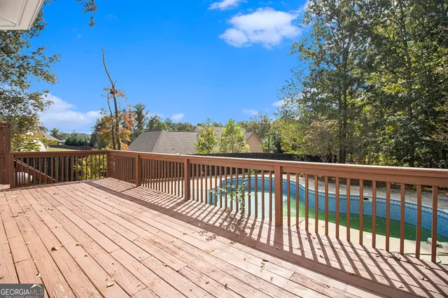 a view of balcony with wooden floor and fence