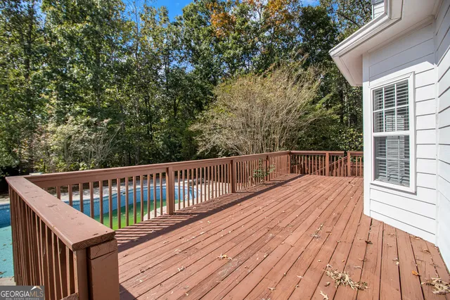 a view of balcony with wooden floor and fence