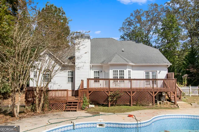 a view of a patio with table and chairs with wooden fence and plants