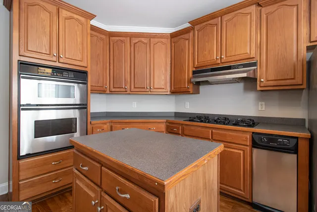 a kitchen with stainless steel appliances granite countertop a refrigerator and cabinets