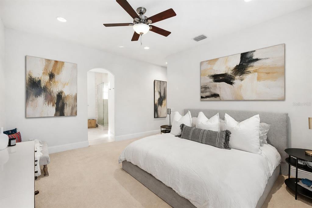 1732 Ridgewood Avenue, Unit S Maitland, FL 32751 - Photo 17 of 31 a bedroom with a large bed and a chandelier