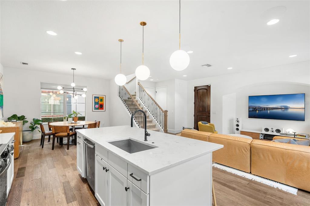 1732 Ridgewood Avenue, Unit S Maitland, FL 32751 - Photo 10 of 31 a kitchen with a sink a counter and chairs