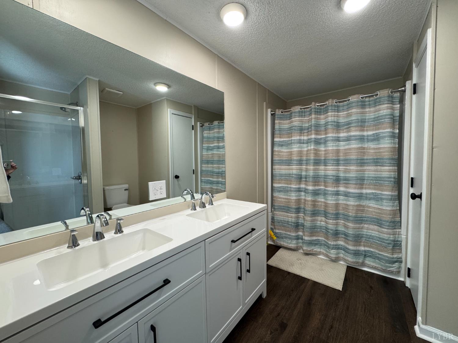 5532 Watt Abbitt Road Appomattox, VA 24522 - Photo 23 of 26 a bathroom with a double vanity sink toilet and shower