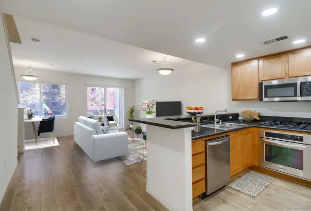 a kitchen with a sink cabinets and wooden floor