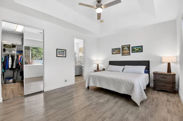 a bathroom with a granite countertop sink mirror and a shower