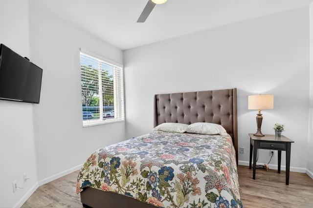 a bathroom with a sink a toilet a mirror and shower