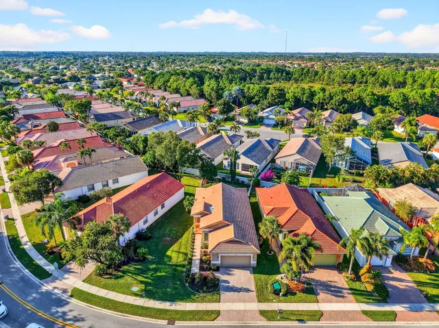 a living room with furniture large window and wooden floor