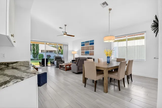 a view of a dining room with furniture wooden floor and chandelier