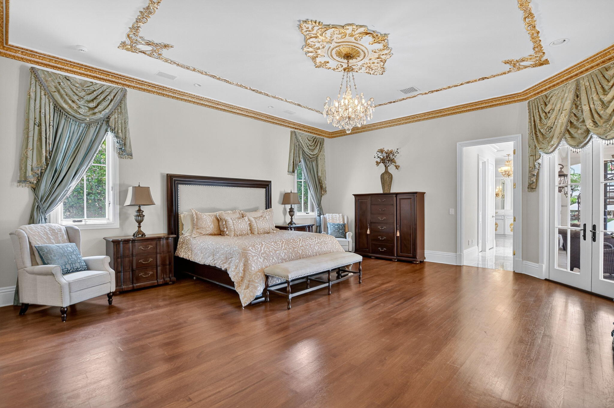 377 East Coconut Palm Road Boca Raton, FL 33432 - Photo 48 of 113 a spacious bedroom with a bed and a chandelier
