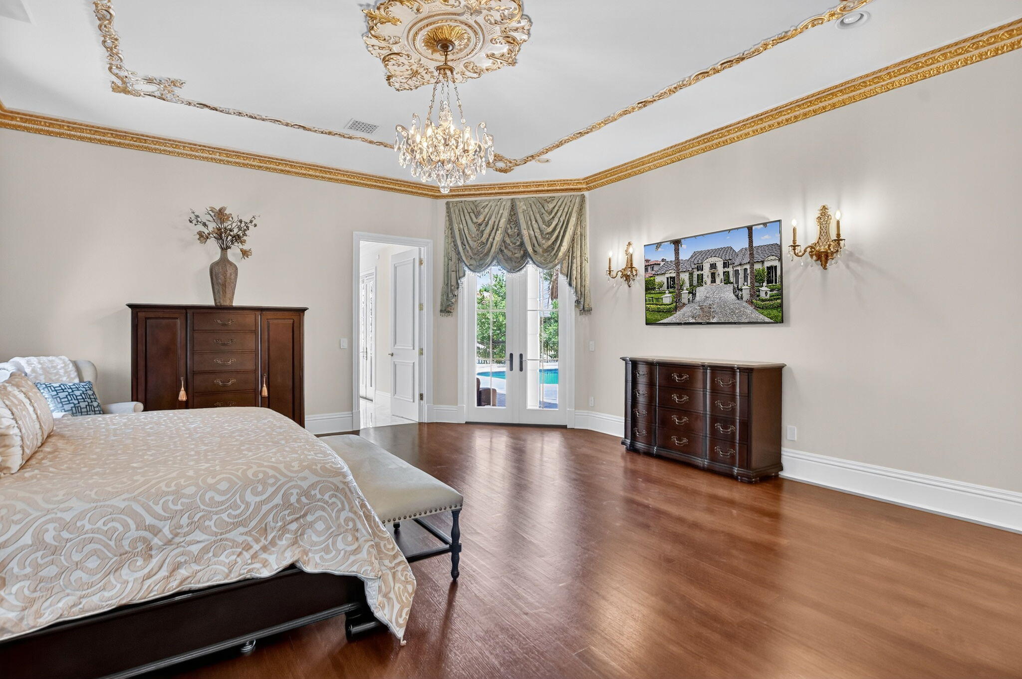 377 East Coconut Palm Road Boca Raton, FL 33432 - Photo 49 of 113 a spacious bedroom with a bed and a fireplace with wooden floor